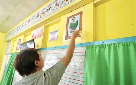 Sara orders removal of wall decorations in classrooms.